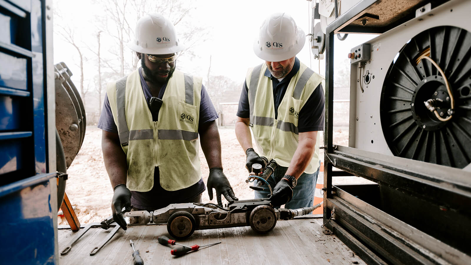 Sewer inspection crew reviewing CCTV footage in the field